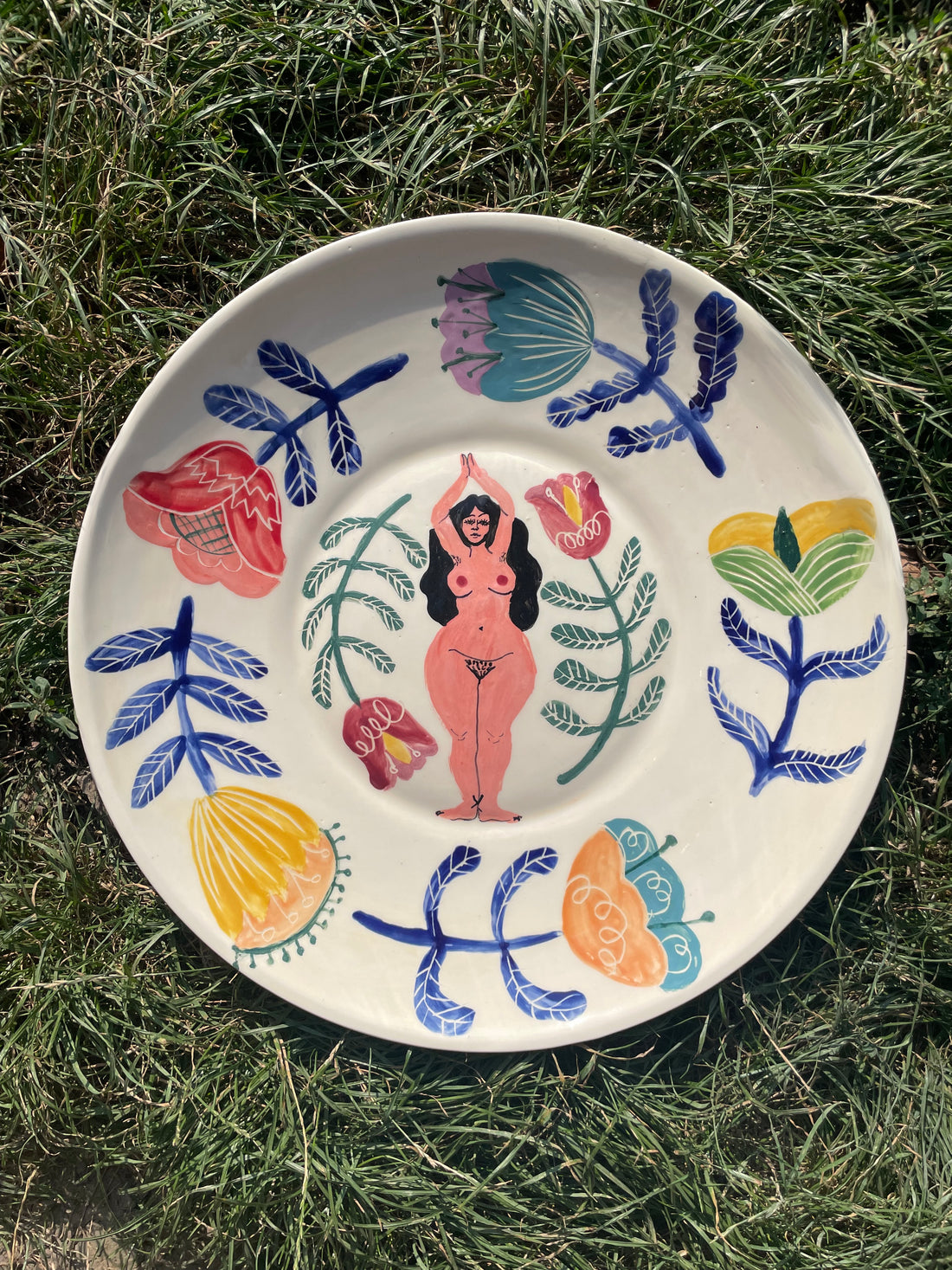 Wall decoration ceramic plate with a goddess figurine and flowers